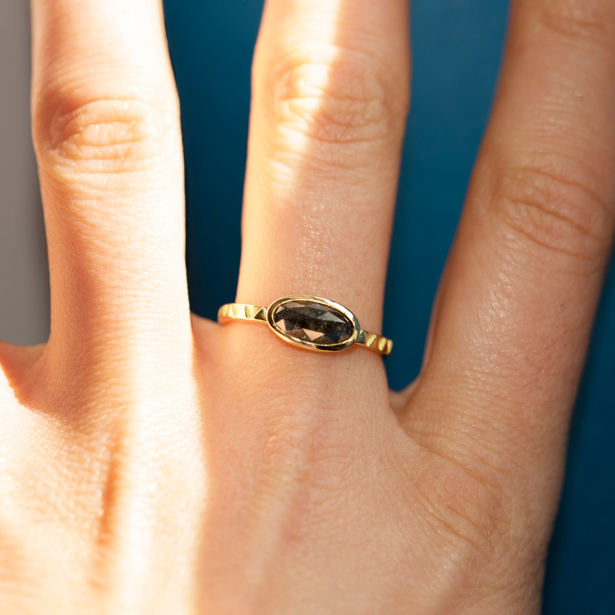 Eclipse 18ct Gold & Grey Oval Diamond Ring worn on a hand, showing the full ring on the finger.