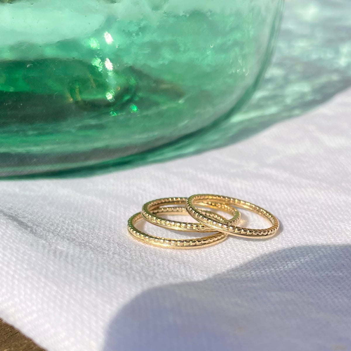 Close-up of the Duo Gold Ring on a fabric background