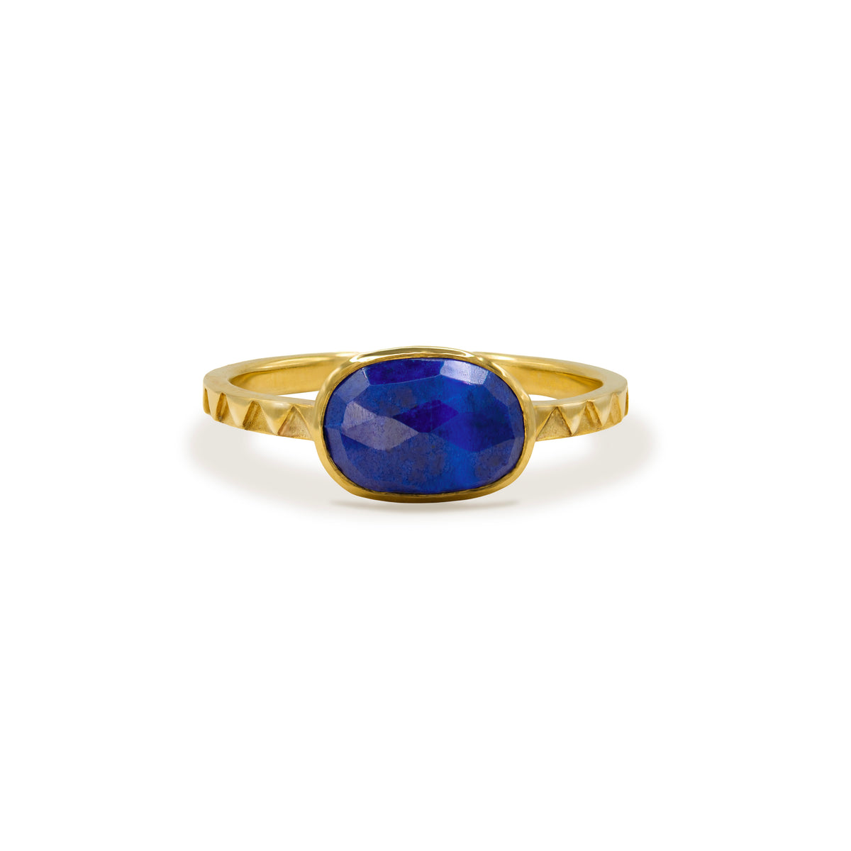 Gold Ring with Faceted Lapis Lazuli Stone, an oval faceted lapis lazuli set on a triangular-patterned Atlas band, shown on a white background.