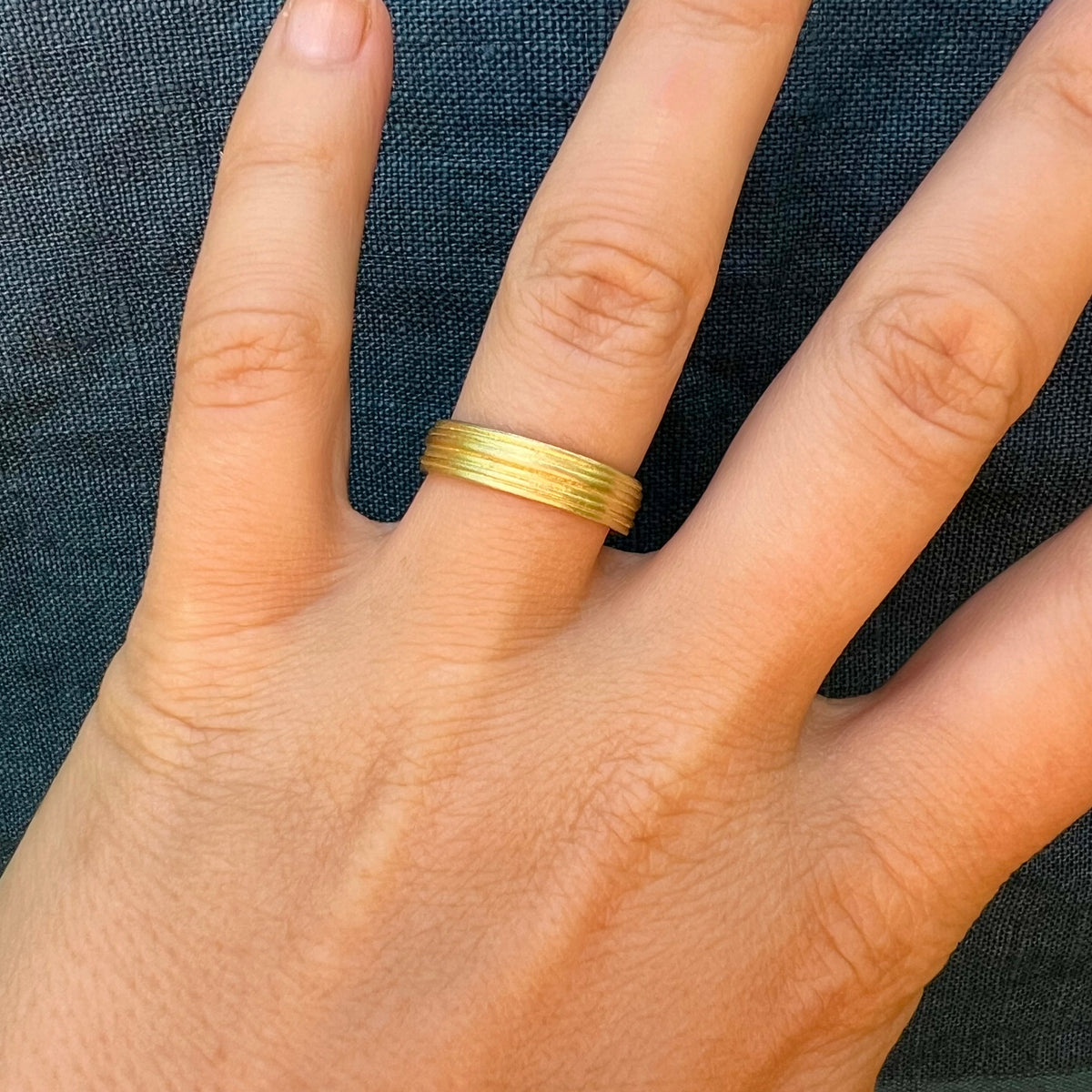 Linear Gold Banded Ring worn on a hand